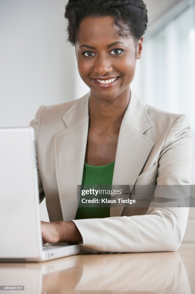 Businesswoman working on laptop at desk