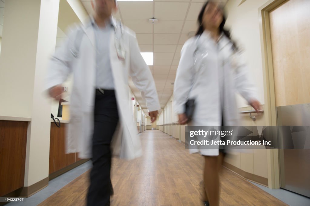 Doctors walking in hospital corridor