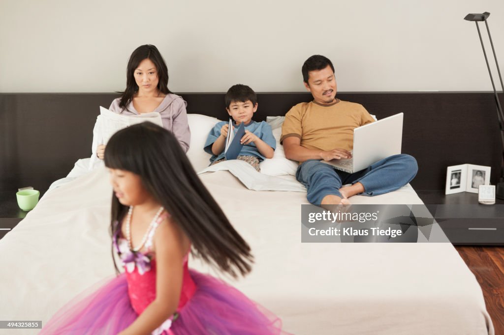 Family relaxing together in bedroom