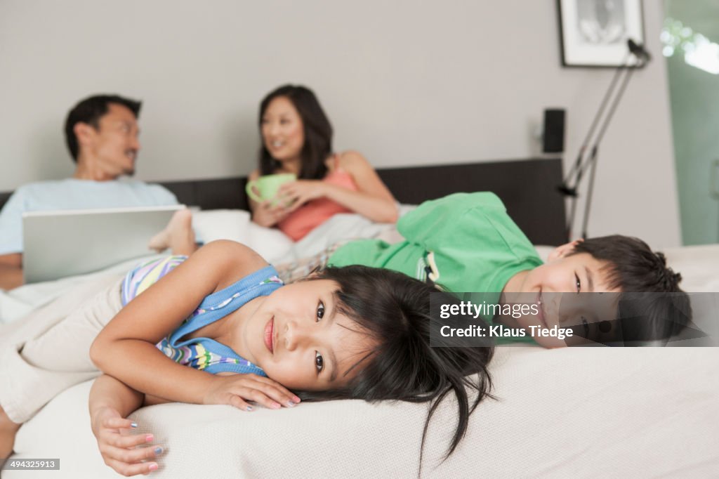 Children playing in parents' bed