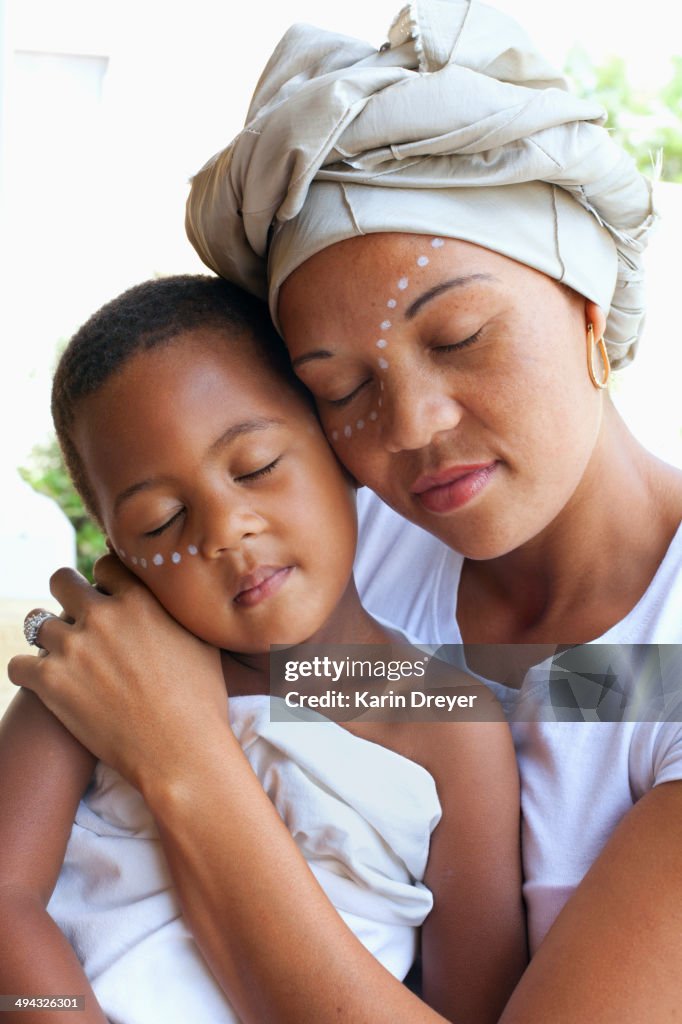 Mixed race mother and daughter hugging