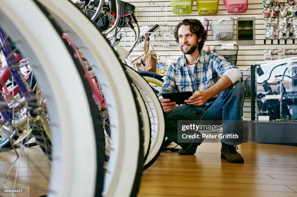 Caucasian man working in bicycle shop