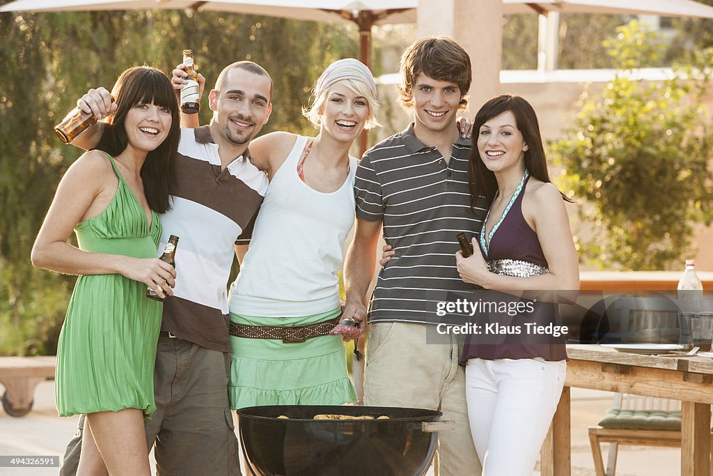 Friends having barbecue outdoors