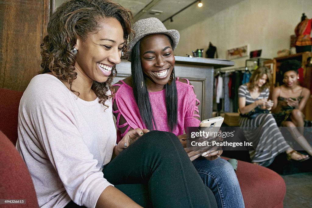 Women using cell phone in store