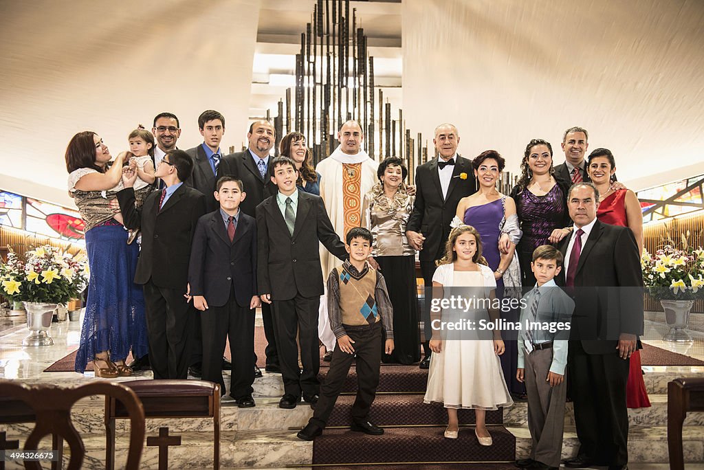 Family posing at wedding in church