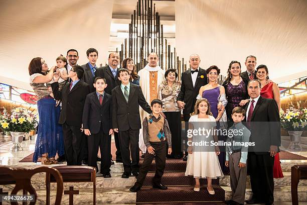 family posing at wedding in church - mexican catholic stock pictures, royalty-free photos & images