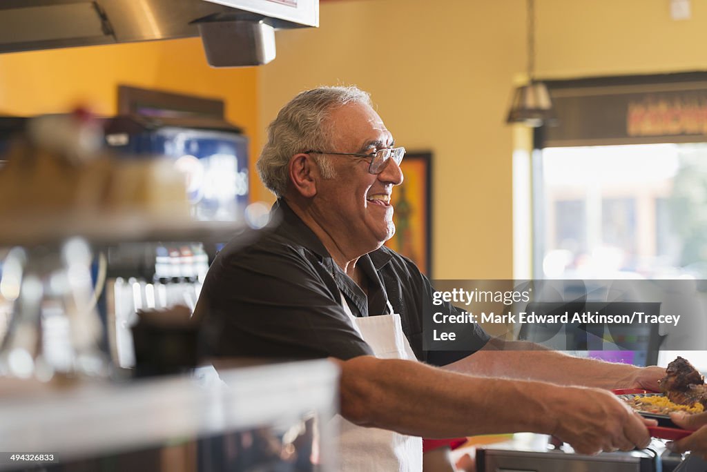 Hispanic server working in cafe