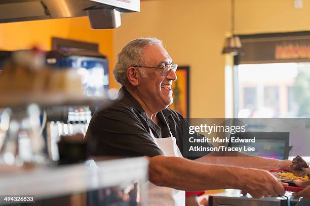 hispanic server working in cafe - trabalho na terceira idade - fotografias e filmes do acervo