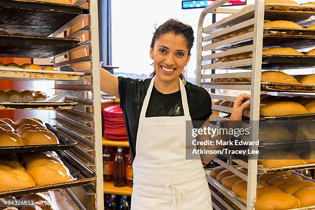 hispanic baker working in commercial kitchen - bakery apron bildbanksfoton och bilder