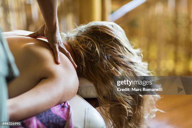 caucasian woman having massage - bali massage ストックフォトと画像