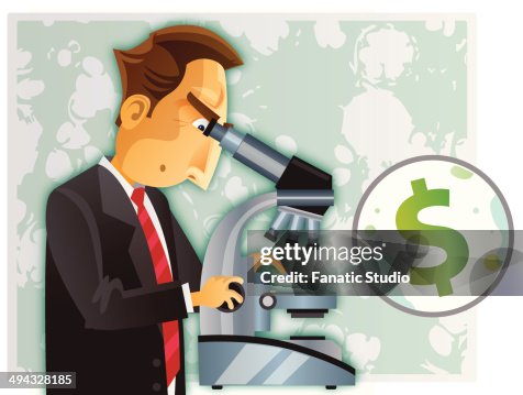 Man examining through a microscope Man examining through a microscope