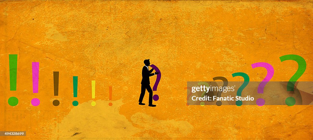 Illustration of businessman holding question mark