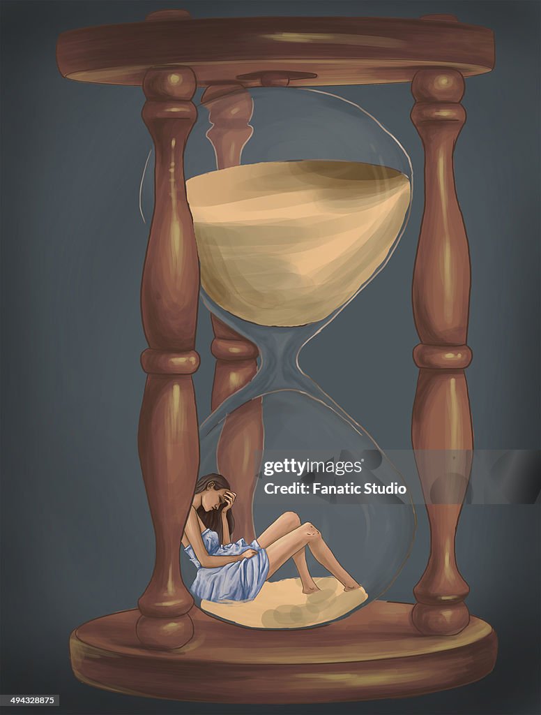 Conceptual shot of woman trapped in hourglass representing menopause