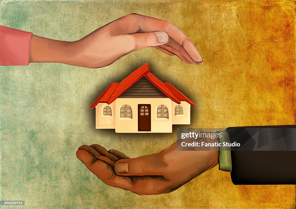 Illustrative image of human hands shielding model house representing home insurance