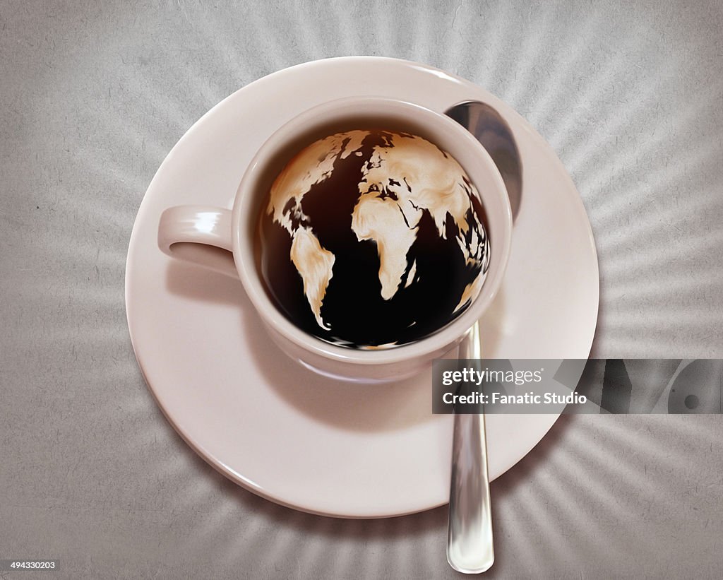 Close-up of world map imprinted in coffee representing morning coffee