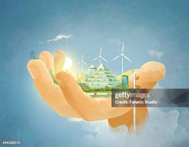illustrative image of building and wind turbines in human hand representing environment conservation - wind turbine close up stock illustrations