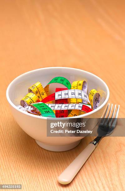 bowl of tape measure pasta - eating disorder conceptual stock pictures, royalty-free photos & images