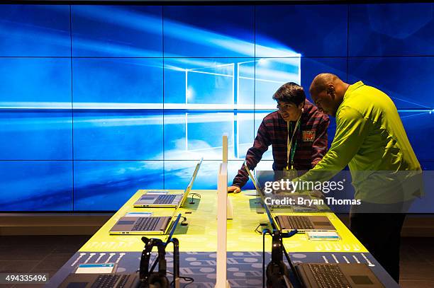 An employee helps a customer use a Dell computer at Microsoft's first flagship store on Fifth Avenue on October 26, 2015 in New York City. Hundreds...