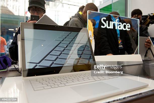Customers view the Surface Pro tablet computer during the opening of the first Microsoft Corp. Store in New York, U.S., on Monday, Oct. 26, 2015. In...