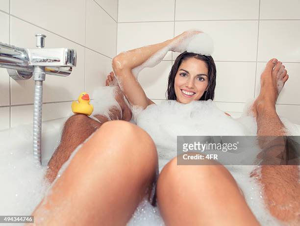 foam fun, couple taking a bath - woman bath tub wet hair stock pictures, royalty-free photos & images