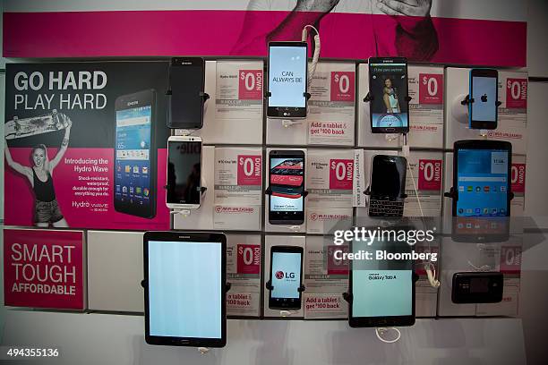 Tablets and smartphones are displayed inside a T-Mobile US Inc. Store in New York, U.S., on Monday, Oct. 26, 2015. T-Mobile US Inc. Is scheduled to...