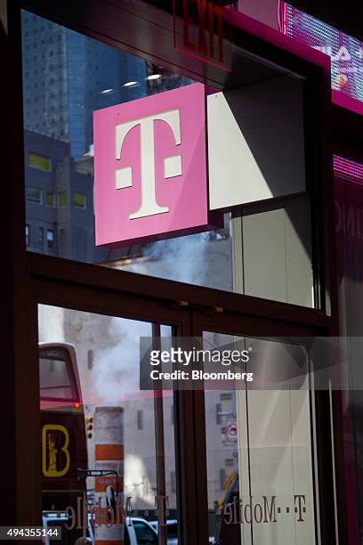 The T-Mobile US Inc. Logo is displayed outside a store in New York, U.S., on Monday, Oct. 26, 2015. T-Mobile US Inc. Is scheduled to release earnings...