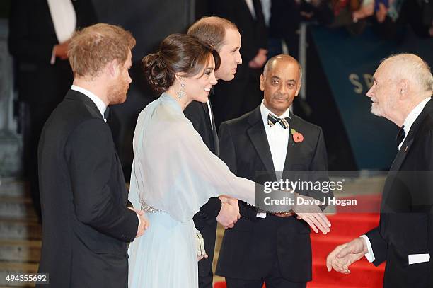 Prince Harry, Catherine, Duchess of Cambridge and Prince William, Duke of Cambridge greet Michael G Wilson during the Royal World Premiere of...