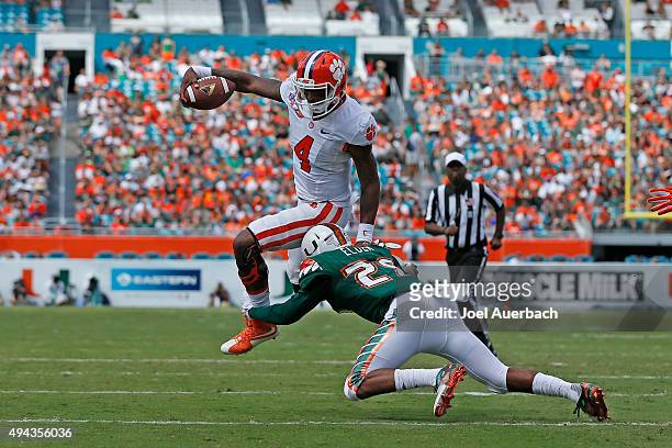 Deshaun Watson of the Clemson Tigers attempts to elude the tackle by Corn Elder of the Miami Hurricanes on October 24, 2015 at Sun Life Stadium in...