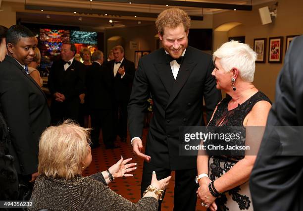 Prince Harry meets charity representatives as he attends The Cinema and Television Benevolent Fund's Royal Film Performance 2015 of the 24th James...
