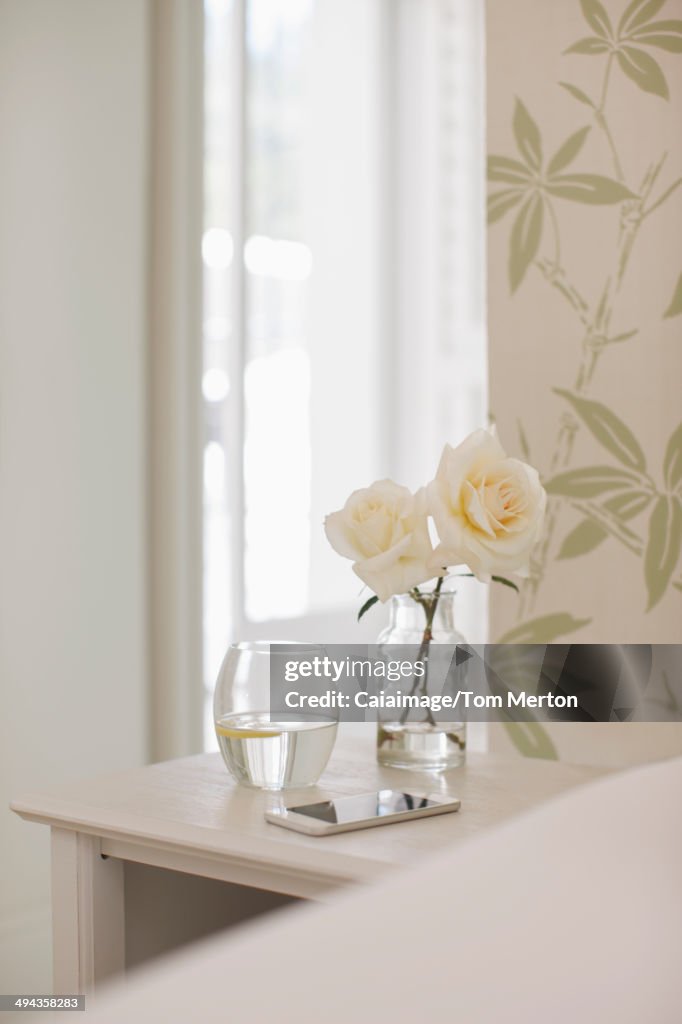 White roses on bedside table