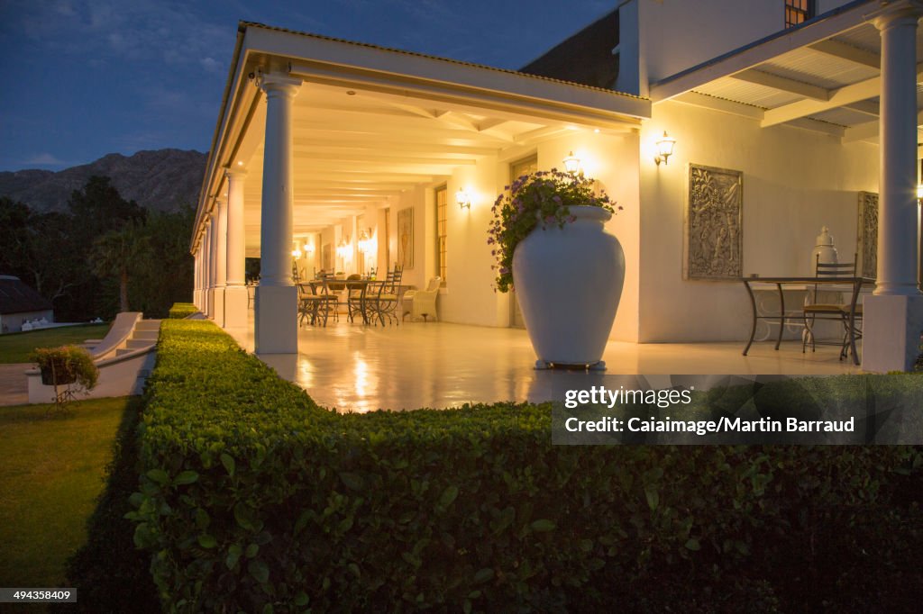 Luxury house with porch illuminated at night
