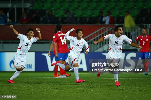 Kim Yong Saeng, Jong Chang Bom and Choe Song Hyok of Korea DPR celebrate Jong's goal in extra time to make the score 2-1 against Costa Rica during...