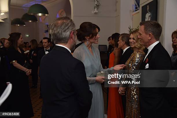 Catherine, Duchess of Cambridge talks with Daniel Craig while attending The Cinema and Television Benevolent Fund's Royal Film Performance 2015 of...