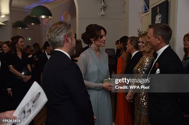 Catherine, Duchess of Cambridge talks with Daniel Craig while attending The Cinema and Television Benevolent Fund's Royal Film Performance 2015 of...