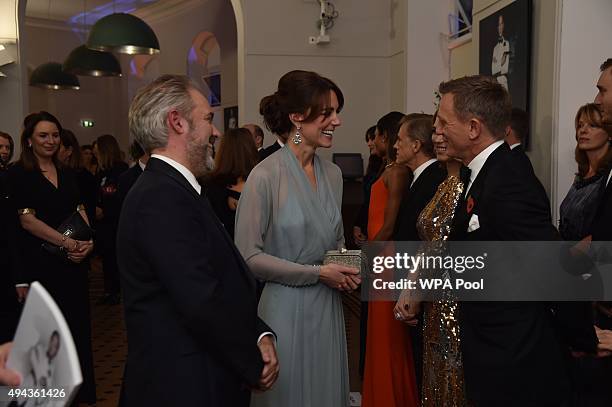 Catherine, Duchess of Cambridge talks with Daniel Craig while attending The Cinema and Television Benevolent Fund's Royal Film Performance 2015 of...