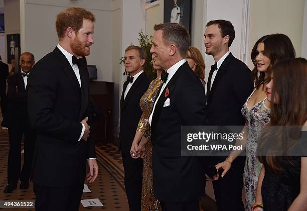 Prince Harry talks with Daniel Craig while attending The Cinema and Television Benevolent Fund's Royal Film Performance 2015 of the 24th James Bond...