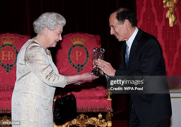 Queen Elizabeth II presents The Queen Elizabeth Prize for Engineering to Dr Robert Langer during a reception in the Throne Room at Buckingham Palace...