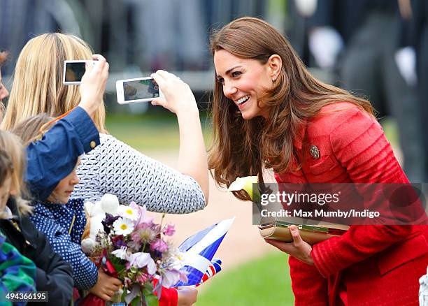 Catherine, Duchess of Cambridge being photographed members of the public whilst on a walkabout in MacRosty Park on a day of engagements in Strathearn...