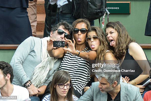 Hosts Karine Le Marchand and Stephane Plaza attend the Roland Garros French Tennis Open 2014 - Day 5 on May 29, 2014 in Paris, France.