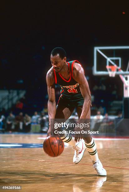 Sidney Moncrief of the Milwaukee Bucks dribbles the ball against the Washington Bullets during an NBA basketball game circa 1984 at the Capital...