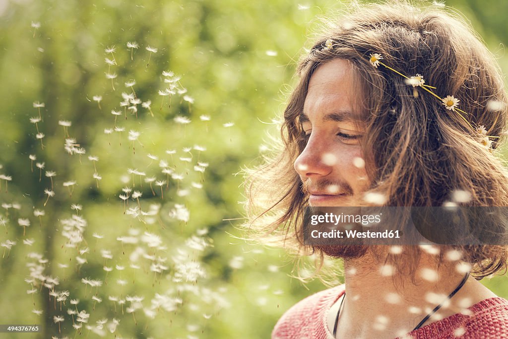 Smiling young man with blowball
