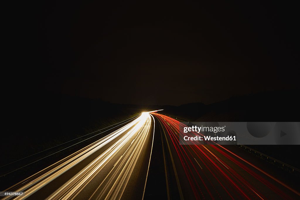 Germany, red and white lighttrails on freeway by night, long exposure