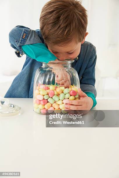 germany, munich, boy with candy jar - candy jar stock pictures, royalty-free photos & images