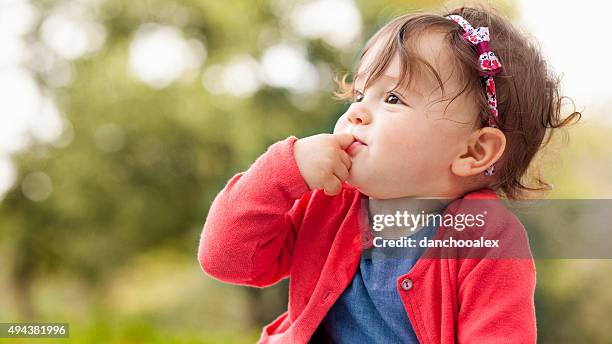 cute baby girl outdoors on the grass - baby girl stock pictures, royalty-free photos & images