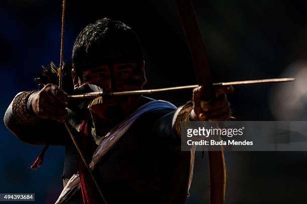 An indigenous man fires an arrow during the bow-and-arrow competition at the first World Games for Indigenous Peoples on October 26, 2015 in Palmas,...