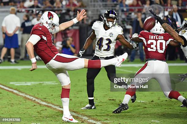 Drew Butler's of the Arizona Cardinals punt is blocked by cornerback Asa Jackson of the Baltimore Ravens in the fourth quarter of the NFL game at...