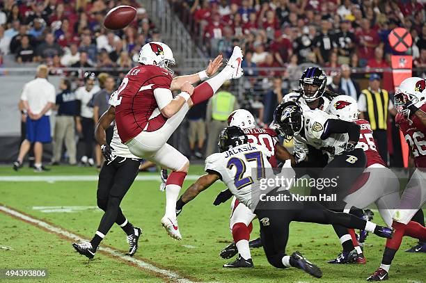 Drew Butler's of the Arizona Cardinals punt is blocked by cornerback Asa Jackson of the Baltimore Ravens in the fourth quarter of the NFL game at...