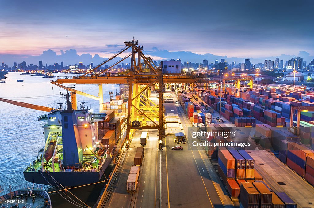 Cargo ship in the harbor at sunset .