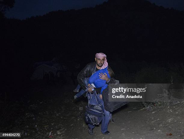 Syrian refugees are seen as carrying their stuff, after fleeing from Russian airstrikes, in Latakia, Syria on October 26, 2015. About 20.000 Syrians...