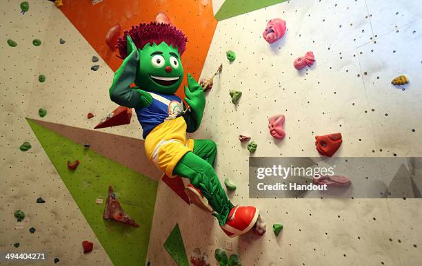 In this handout image provided by Glasgow 2014 Ltd, Clyde the 2014 Commonwealth Games Mascot holds the Queen's Baton at the Beacon Climbing Centre,...